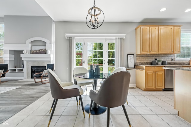13004 Tuscany Blvd, Carmel, IN 46032 - dining area featuring light tile patterned floors, recessed lighting, a tiled fireplace, and a chandelier