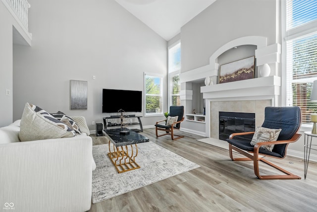 13004 Tuscany Blvd, Carmel, IN 46032 - living area featuring high vaulted ceiling, a fireplace, and wood finished floors