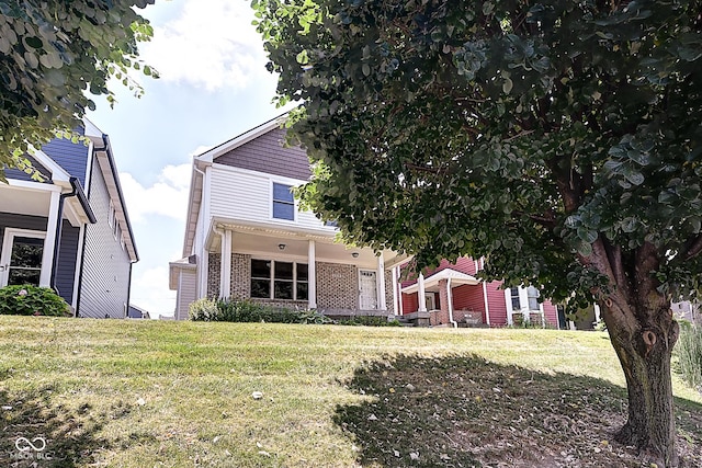 1319 E Michigan St, Indianapolis, IN 46202 - obstructed view of property with brick siding and a front lawn