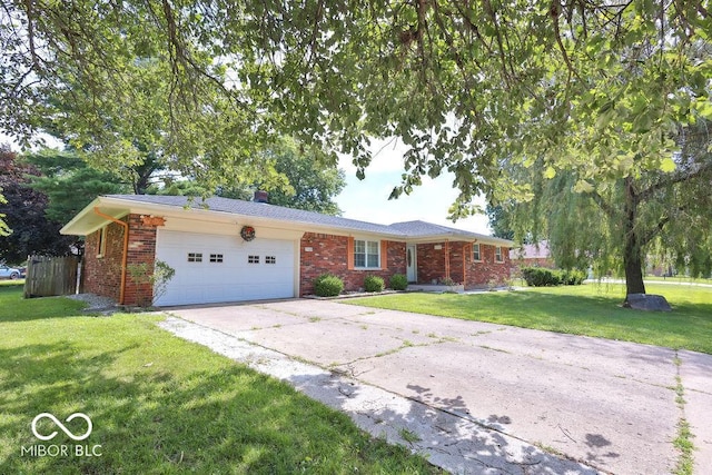 7525 Surrey Dr, Indianapolis, IN 46227 - ranch-style house with an attached garage, brick siding, driveway, and a front lawn
