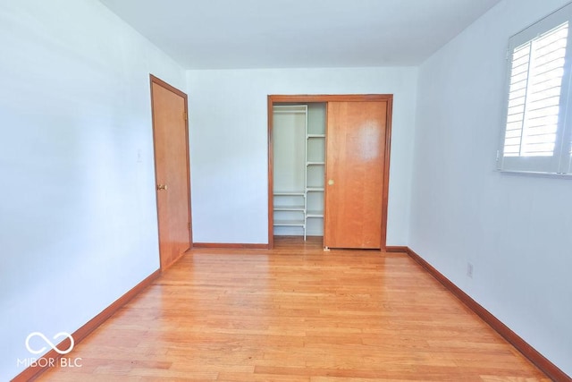 7525 Surrey Dr, Indianapolis, IN 46227 - unfurnished bedroom with light wood finished floors and a closet