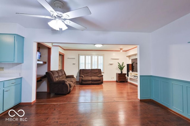 7525 Surrey Dr, Indianapolis, IN 46227 - living room with dark wood-style floors, ceiling fan, and a wainscoted wall