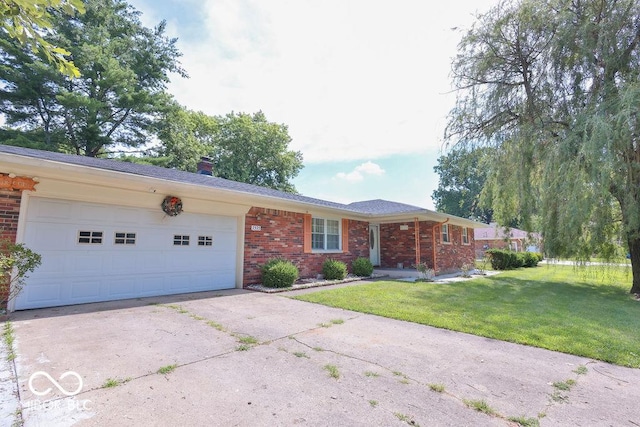 7525 Surrey Dr, Indianapolis, IN 46227 - ranch-style home featuring brick siding, concrete driveway, a front yard, a chimney, and a garage