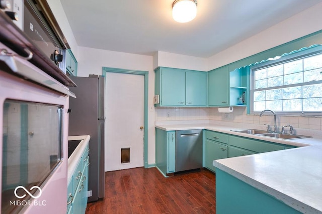 7525 Surrey Dr, Indianapolis, IN 46227 - kitchen featuring appliances with stainless steel finishes, decorative backsplash, dark wood-style floors, and light countertops