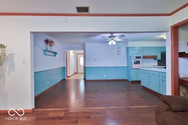 7525 Surrey Dr, Indianapolis, IN 46227 - living room with wainscoting, dark wood finished floors, ceiling fan, and crown molding