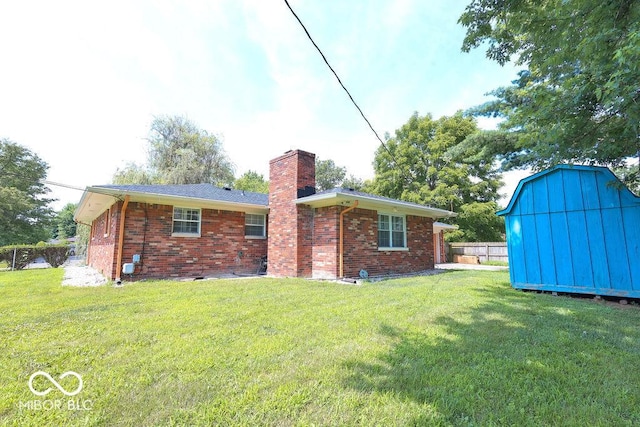 7525 Surrey Dr, Indianapolis, IN 46227 - back of house with a chimney, a shed, and brick siding