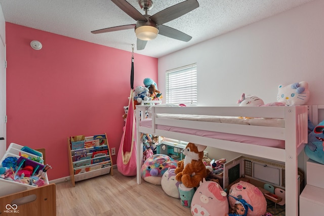 2564 Woodfield Blvd, Franklin, IN 46131 - bedroom featuring wood finished floors, a textured ceiling, and a ceiling fan