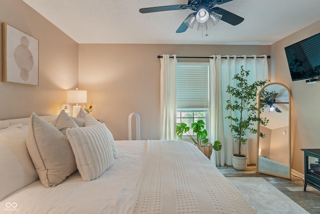 2564 Woodfield Blvd, Franklin, IN 46131 - bedroom with wood finished floors, a ceiling fan, and a textured ceiling
