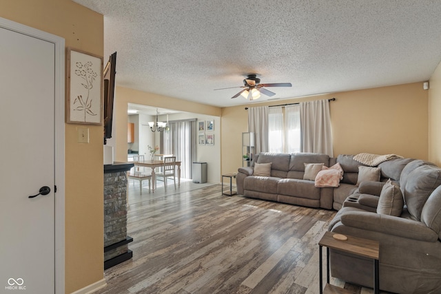 2564 Woodfield Blvd, Franklin, IN 46131 - living area with a textured ceiling, ceiling fan, wood finished floors, and a chandelier