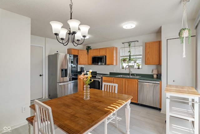 2564 Woodfield Blvd, Franklin, IN 46131 - kitchen with appliances with stainless steel finishes, dark countertops, a chandelier, and pendant lighting