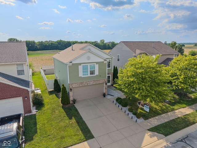 2564 Woodfield Blvd, Franklin, IN 46131 - traditional-style home featuring brick siding, a garage, concrete driveway, and a front lawn