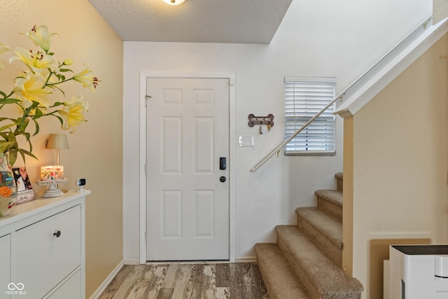2564 Woodfield Blvd, Franklin, IN 46131 - foyer with stairs, light wood-style flooring, and a textured ceiling