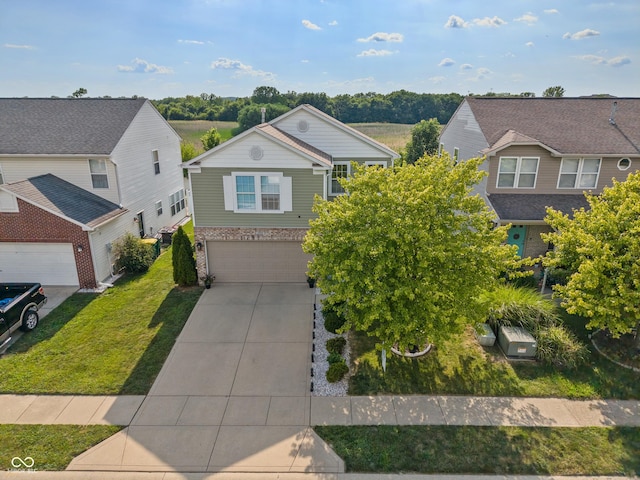 2564 Woodfield Blvd, Franklin, IN 46131 - view of front of property with an attached garage, concrete driveway, a front yard, brick siding, and a residential view