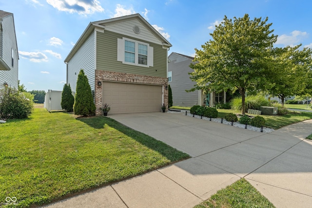 2564 Woodfield Blvd, Franklin, IN 46131 - view of front of property with brick siding, an attached garage, a front lawn, and driveway