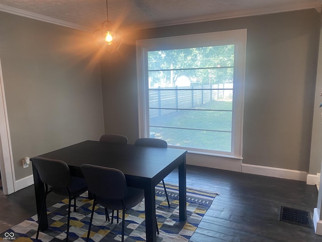 5220 Crawfordsville Rd, Speedway, IN 46224 - dining space with healthy amount of natural light, wood finished floors, and ornamental molding