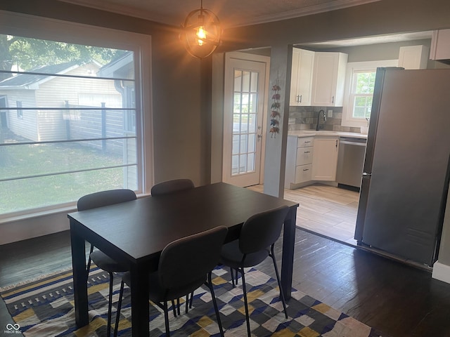 5220 Crawfordsville Rd, Speedway, IN 46224 - dining area with ornamental molding and light wood-style floors