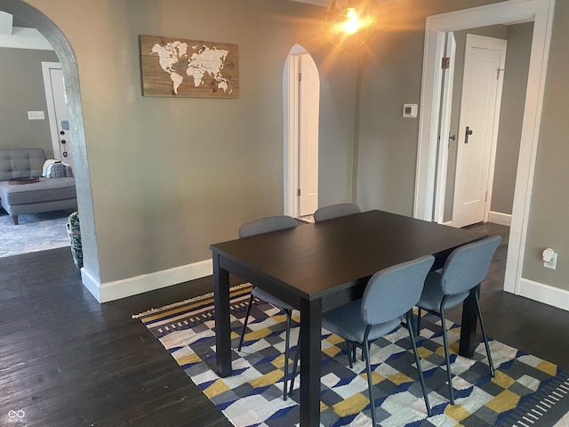 5220 Crawfordsville Rd, Speedway, IN 46224 - dining room featuring arched walkways and wood finished floors