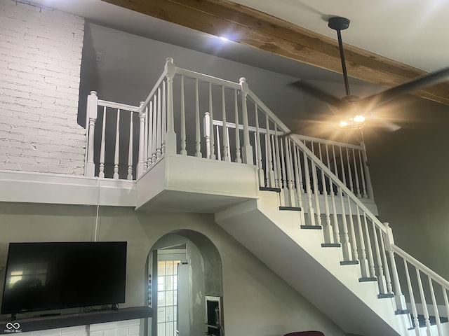 5220 Crawfordsville Rd, Speedway, IN 46224 - stairs with a ceiling fan, a towering ceiling, arched walkways, and beamed ceiling