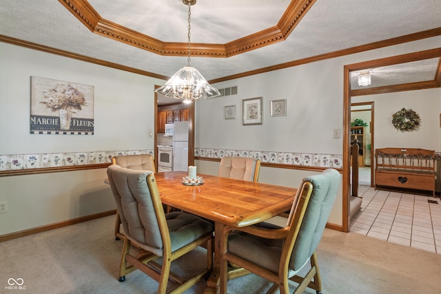 12011 Emory Dr, Indianapolis, IN 46229 - dining space featuring light colored carpet, a textured ceiling, a chandelier, a tray ceiling, and crown molding