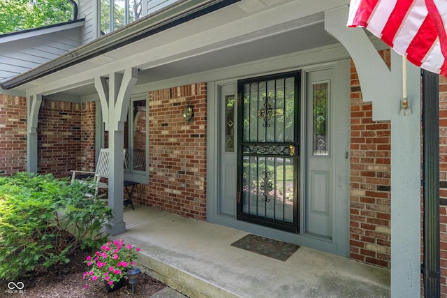 12011 Emory Dr, Indianapolis, IN 46229 - view of exterior entry featuring brick siding and a porch