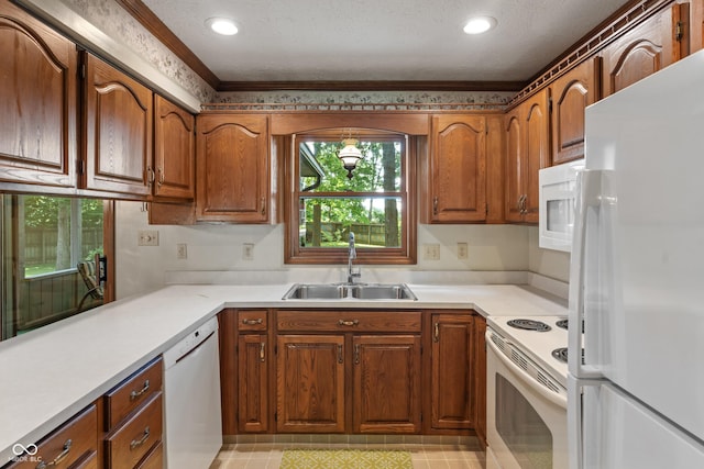 12011 Emory Dr, Indianapolis, IN 46229 - kitchen featuring white appliances, brown cabinets, light countertops, recessed lighting, and ornamental molding