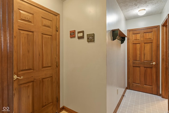 12011 Emory Dr, Indianapolis, IN 46229 - foyer featuring baseboards and a textured ceiling