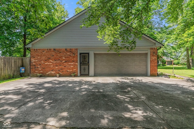 12011 Emory Dr, Indianapolis, IN 46229 - view of home's exterior featuring brick siding, concrete driveway, and a garage