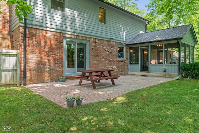 12011 Emory Dr, Indianapolis, IN 46229 - rear view of property with a sunroom, a patio area, and brick siding