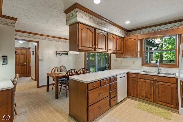 12011 Emory Dr, Indianapolis, IN 46229 - kitchen with a peninsula, brown cabinetry, crown molding, light countertops, and white dishwasher