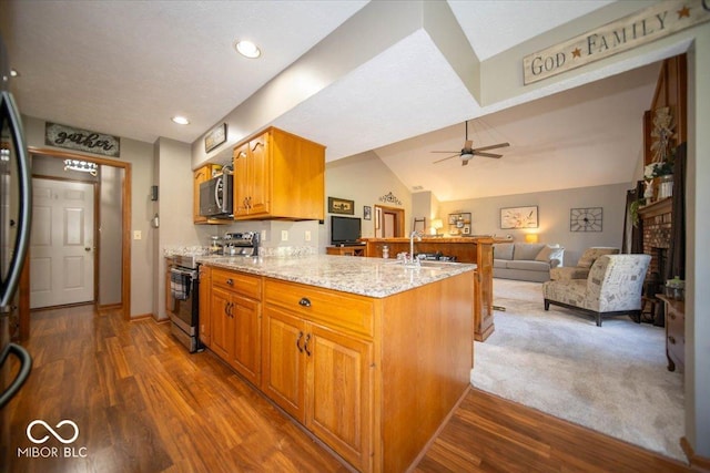 2259 Willow Lake Dr, Greenwood, IN 46143 - kitchen featuring appliances with stainless steel finishes, a peninsula, light stone counters, open floor plan, and dark wood-style floors