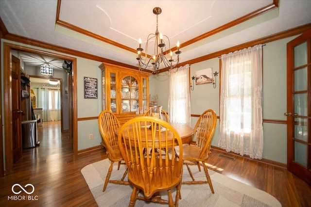 2259 Willow Lake Dr, Greenwood, IN 46143 - dining area with a raised ceiling, a chandelier, wood finished floors, and ornamental molding