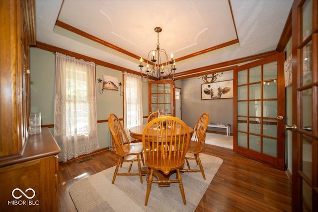 2259 Willow Lake Dr, Greenwood, IN 46143 - dining area with a chandelier, crown molding, a raised ceiling, wood finished floors, and french doors