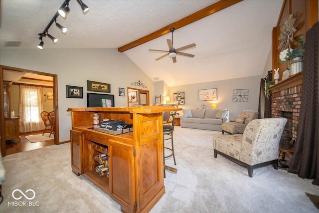 2259 Willow Lake Dr, Greenwood, IN 46143 - living area featuring light carpet, ceiling fan, a fireplace, and track lighting