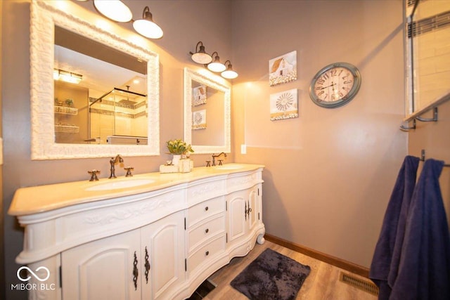 2259 Willow Lake Dr, Greenwood, IN 46143 - full bath with a shower stall, double vanity, and wood finished floors