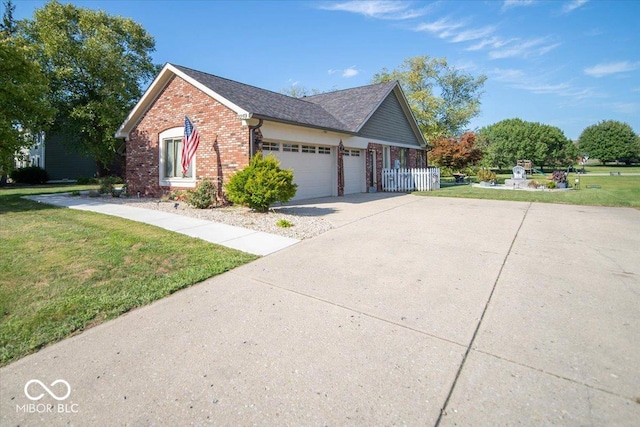 2259 Willow Lake Dr, Greenwood, IN 46143 - view of side of home featuring brick siding, a lawn, an attached garage, and concrete driveway