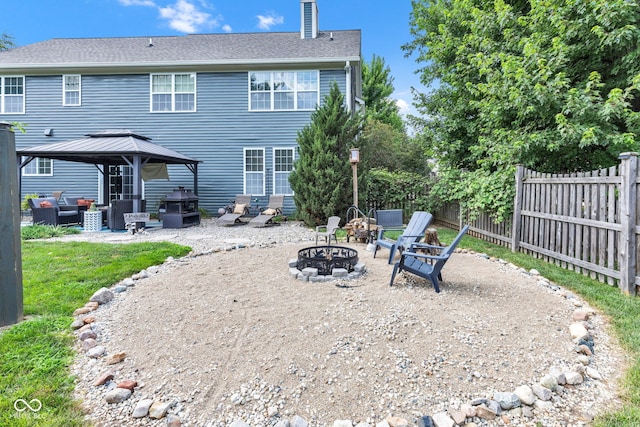 5961 Pine Bluff Dr, Avon, IN 46123 - rear view of property featuring a gazebo, a patio area, a chimney, and an outdoor living space with a fire pit