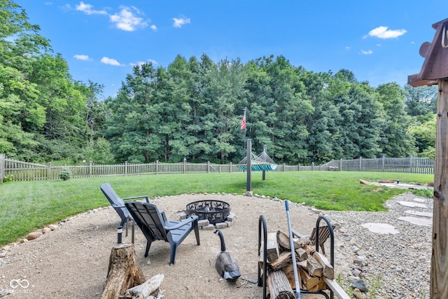 5961 Pine Bluff Dr, Avon, IN 46123 - fenced backyard with an outdoor fire pit and a forest view