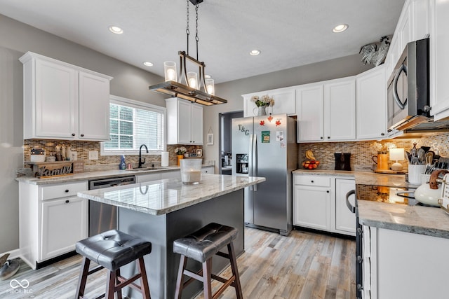 5961 Pine Bluff Dr, Avon, IN 46123 - kitchen with stainless steel appliances, white cabinets, light wood-style floors, recessed lighting, and tasteful backsplash