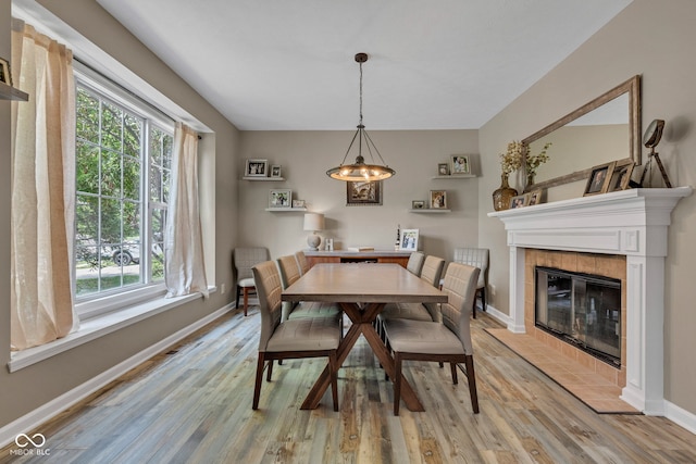 5961 Pine Bluff Dr, Avon, IN 46123 - dining room featuring light wood finished floors, healthy amount of natural light, and a tile fireplace