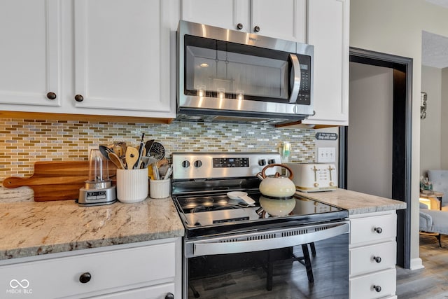 5961 Pine Bluff Dr, Avon, IN 46123 - kitchen featuring stainless steel appliances, white cabinets, tasteful backsplash, and light stone counters