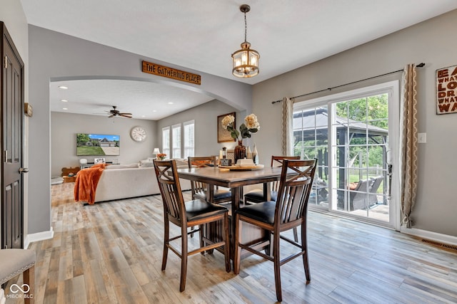 5961 Pine Bluff Dr, Avon, IN 46123 - dining area featuring arched walkways, light wood-style floors, recessed lighting, a chandelier, and a ceiling fan