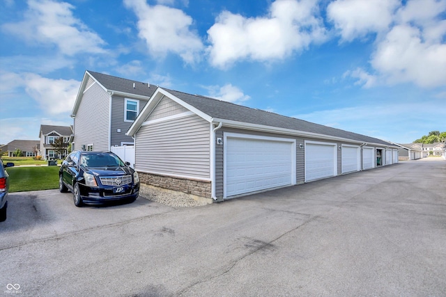 3588 Thomas Jefferson St, Westfield, IN 46074 - view of side of home featuring stone siding, community garages, and a residential view