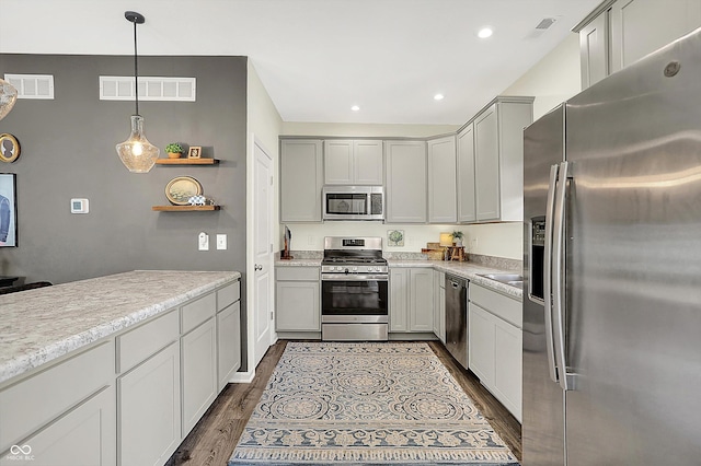 3588 Thomas Jefferson St, Westfield, IN 46074 - kitchen featuring appliances with stainless steel finishes, dark wood finished floors, light countertops, decorative light fixtures, and recessed lighting