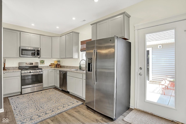 3588 Thomas Jefferson St, Westfield, IN 46074 - kitchen with appliances with stainless steel finishes, light wood-style floors, light countertops, gray cabinets, and recessed lighting