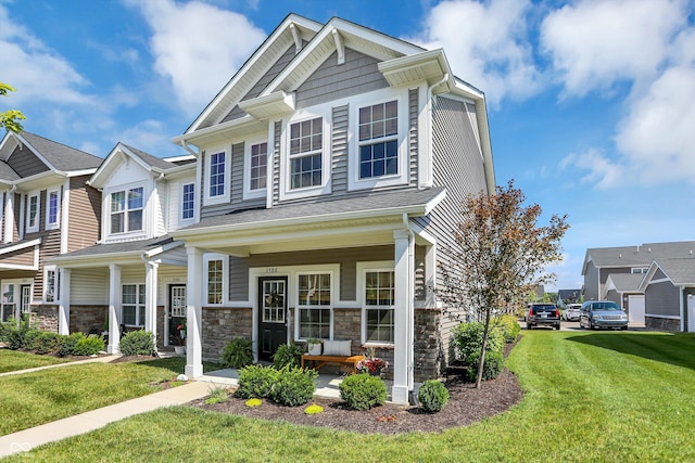 3588 Thomas Jefferson St, Westfield, IN 46074 - craftsman inspired home featuring covered porch, a front yard, and stone siding