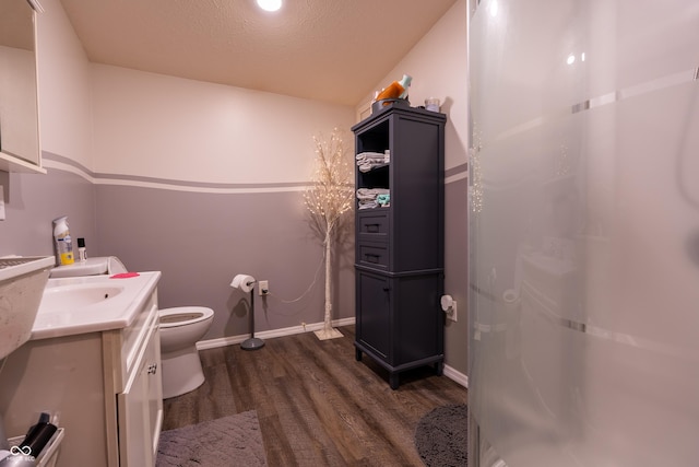 2501 Mitten Rd, Bowling Green, IN 47833 - bathroom featuring vanity, wood finished floors, walk in shower, and a textured ceiling