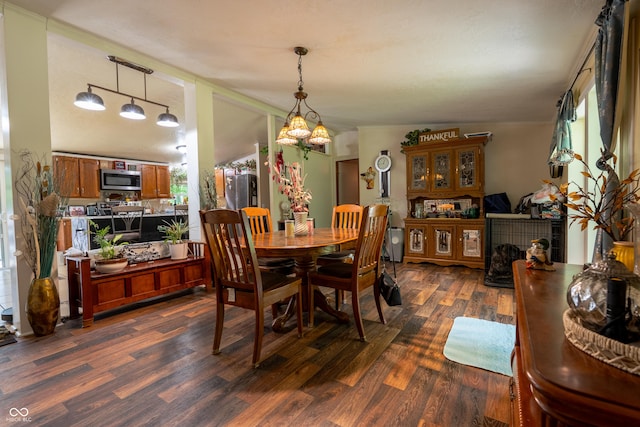2501 Mitten Rd, Bowling Green, IN 47833 - dining area featuring dark wood-type flooring, rail lighting, and a chandelier
