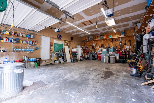 2501 Mitten Rd, Bowling Green, IN 47833 - garage featuring a garage door opener and a workshop area