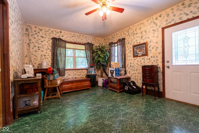 2501 Mitten Rd, Bowling Green, IN 47833 - sitting room featuring wallpapered walls, ceiling fan, and a textured ceiling