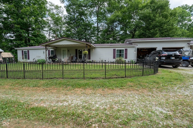 2501 Mitten Rd, Bowling Green, IN 47833 - single story home featuring an attached garage, a fenced front yard, and a metal roof